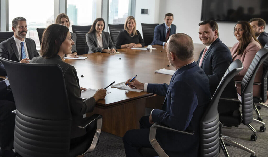 Harris team meeting around large conference room table